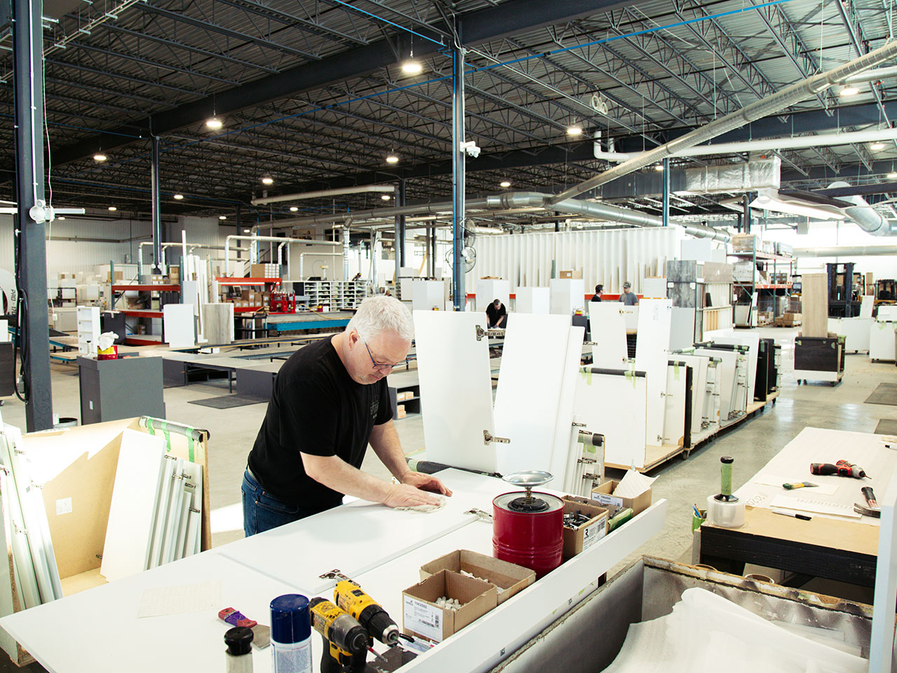 A Cuisi-n-art employee assembling a part on a workbench in the plant